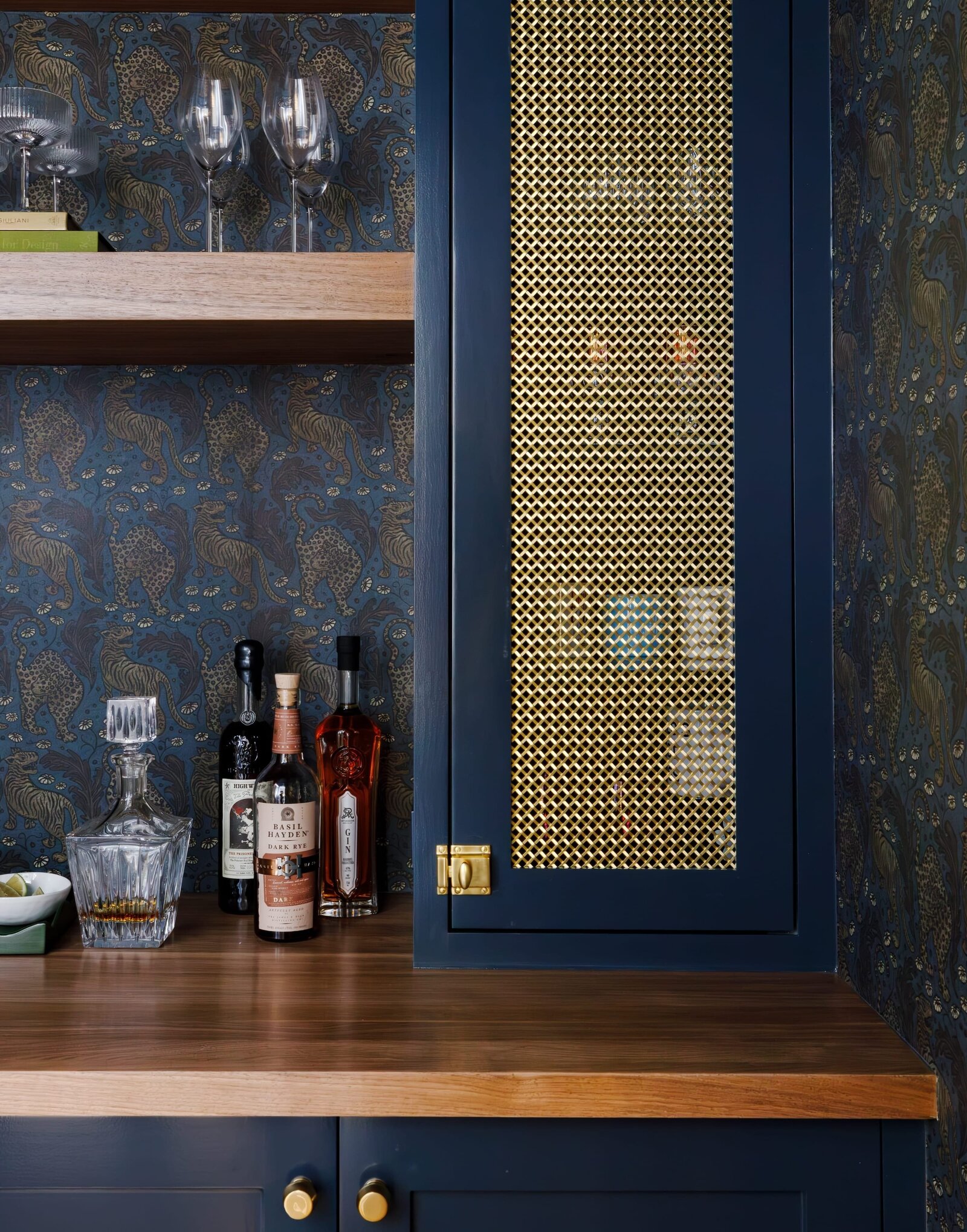 vision and hammer bar counter with dark blue cabinets and wallpaper