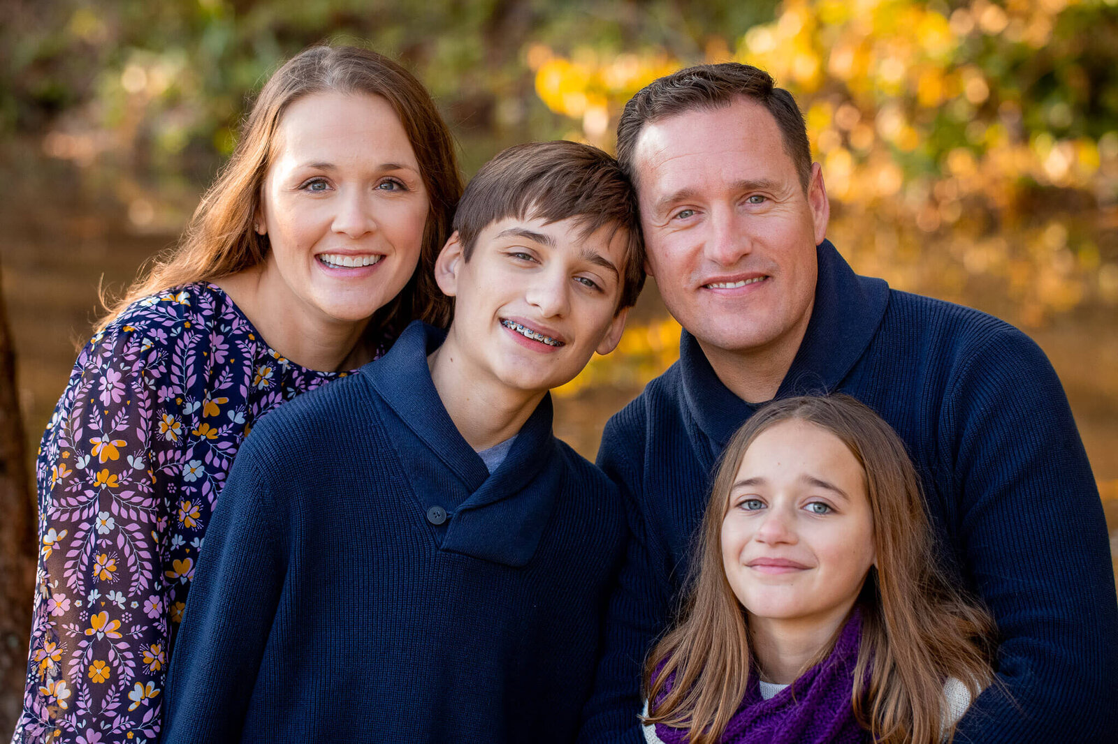 A close-up of a family smiling for Springfield family photographer, Melissa Driggers.