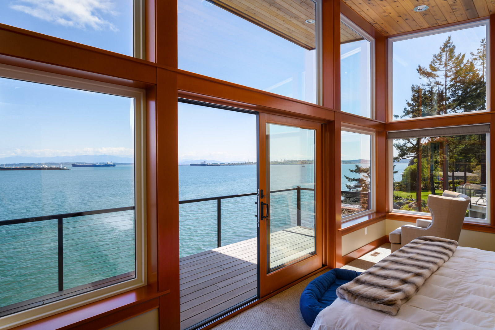 floor to ceiling windows in living room with ocean view