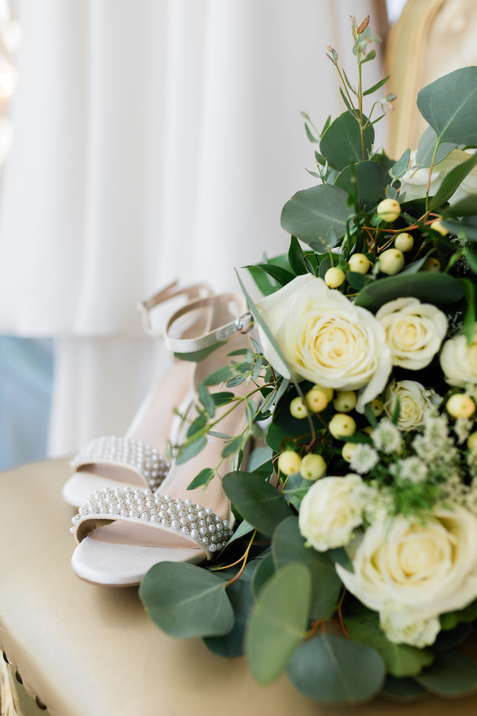 Detail of flowers, shoes, and wedding dress