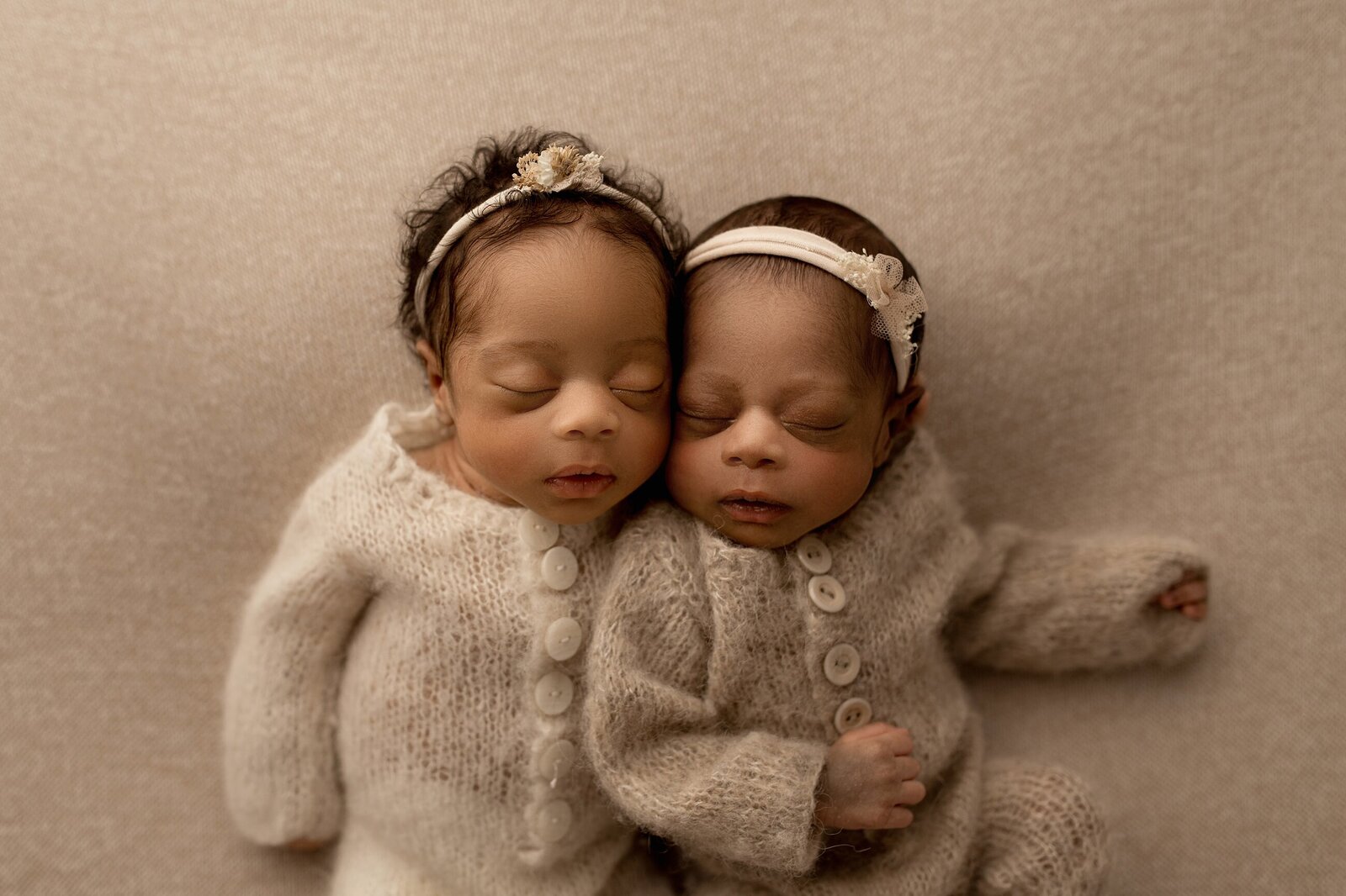 neutral twin girls newborn image with oatmeal heather textured sweaters