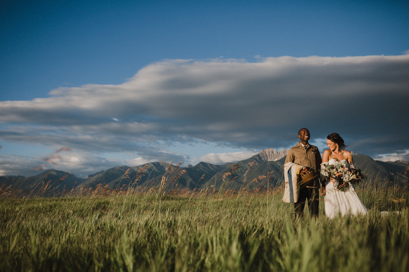 Indie styled bride and groom  have their portraits taken in an open field in Missoula, Montana.
