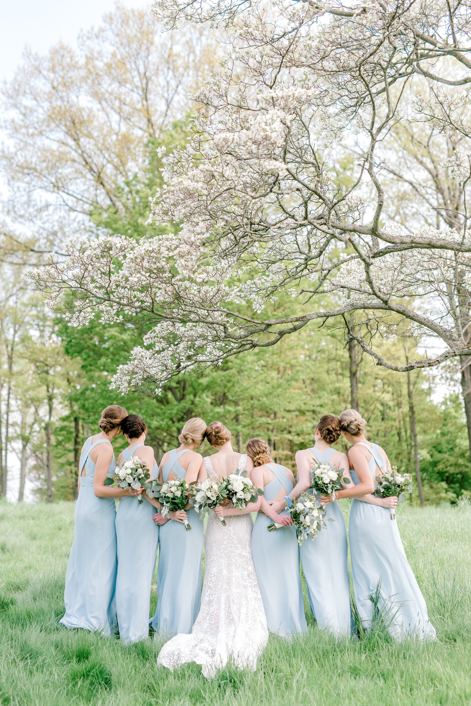 Spring Wedding in Erie PA with gorgeous blue dresses and flowering trees