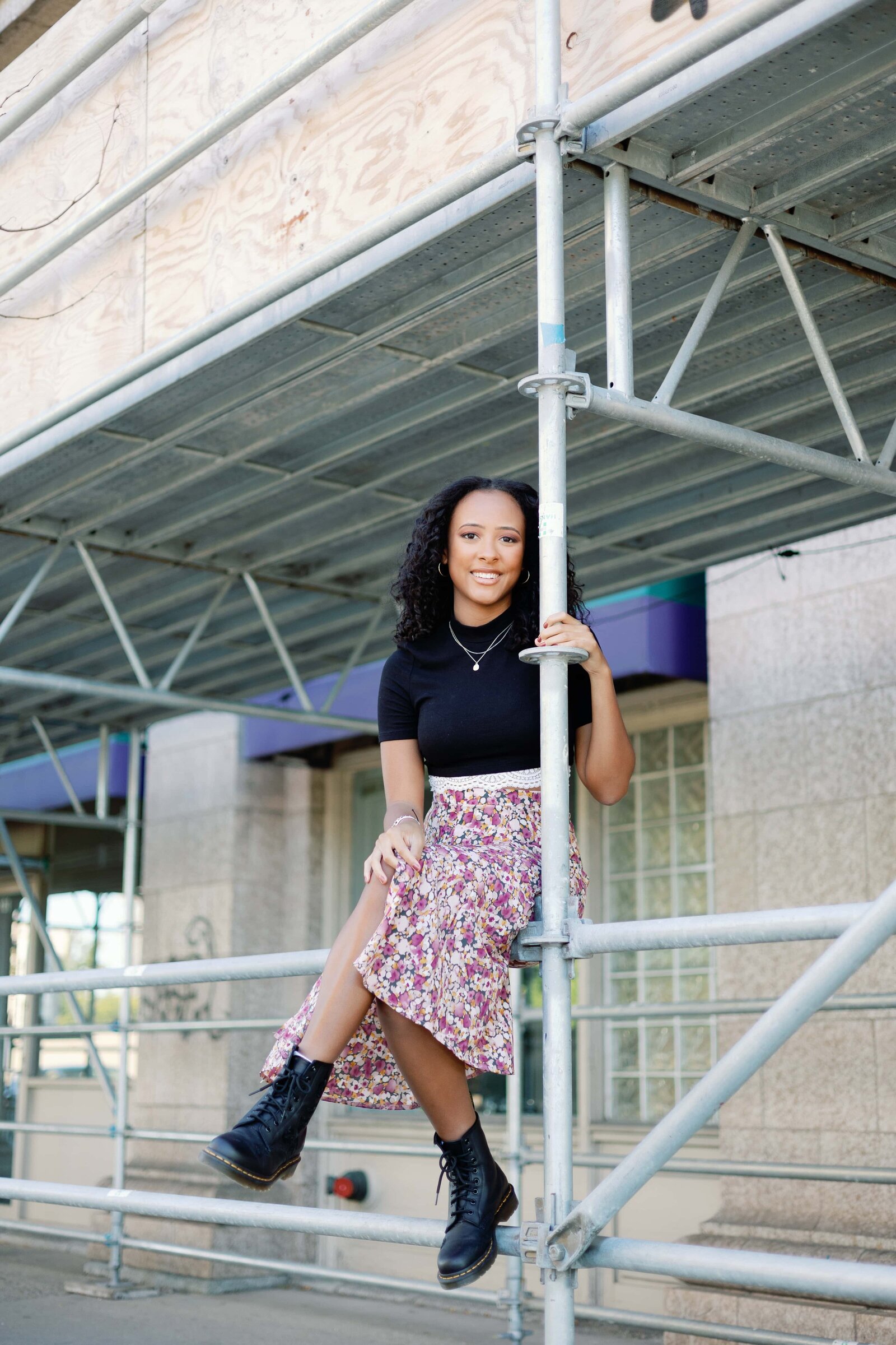 Urban picture of high school senior posing with construction scaffolding in Indianapolis