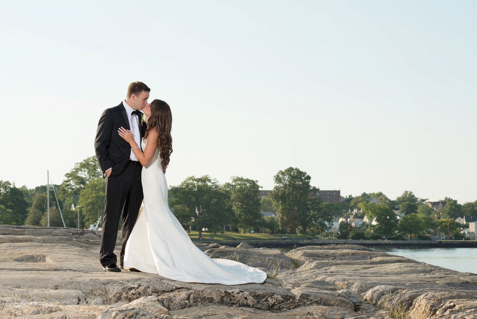 bride and groom outside by the water at Glen Island Harbor Club