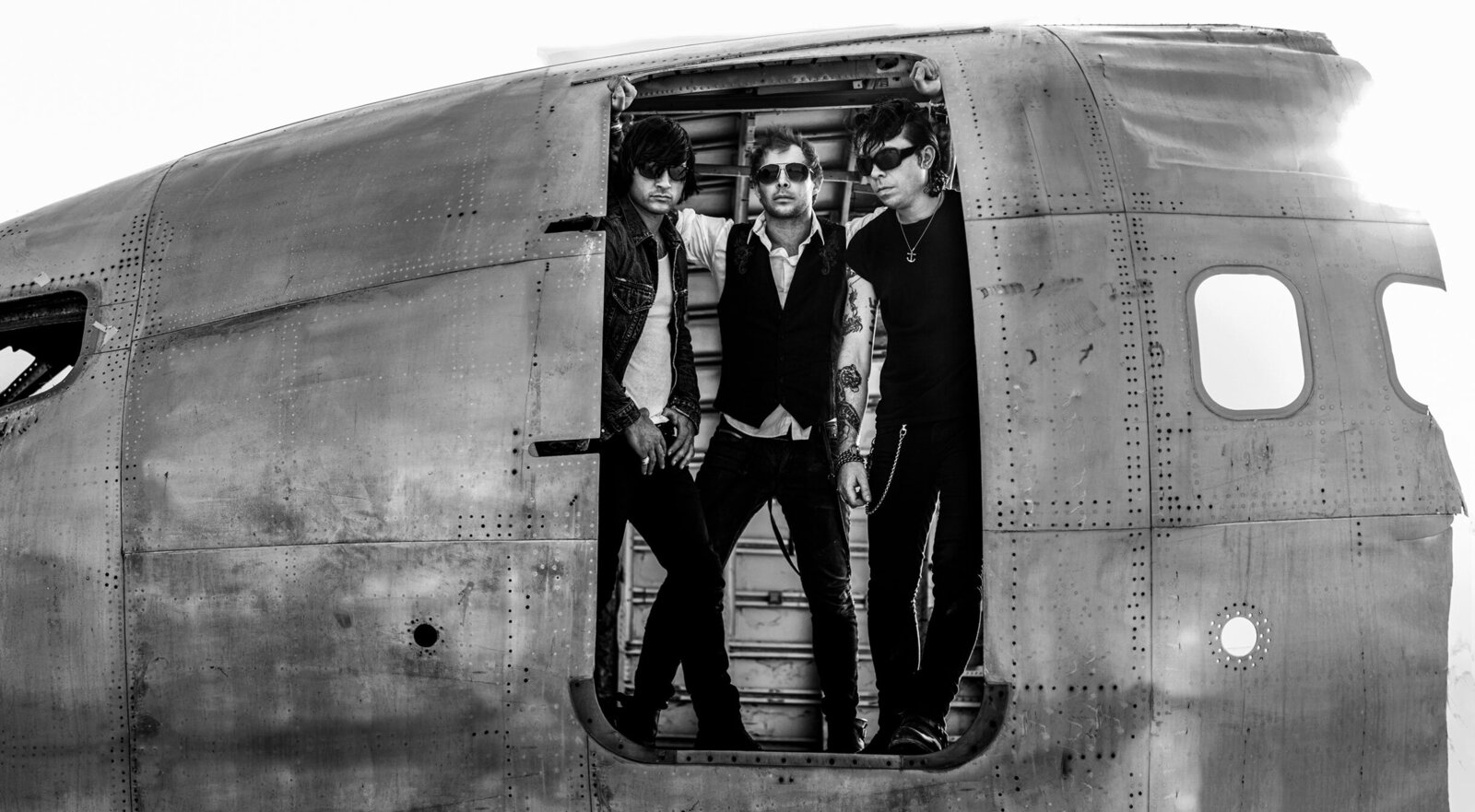 Band Photo Dead Day Revolution three members in doorway of old metal airplane black and white