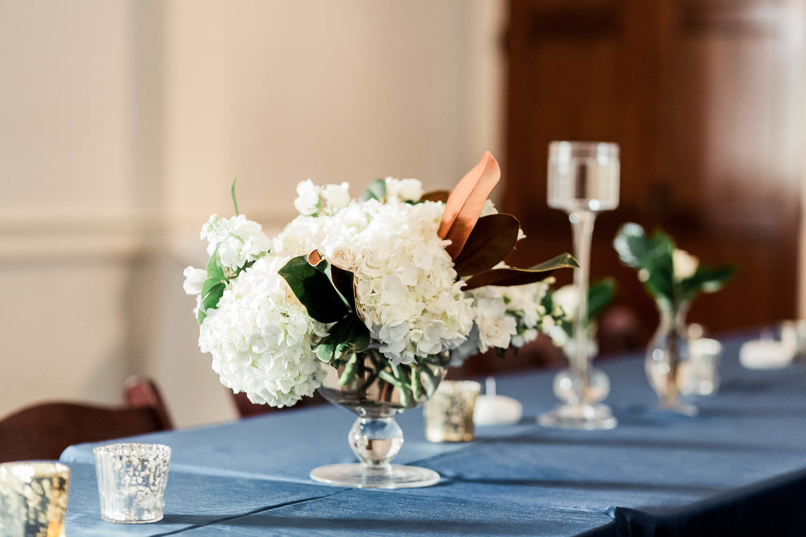 Beautiful floral centerpieces are on each table, Coleman Hall, Charleston Wedding Photographer.