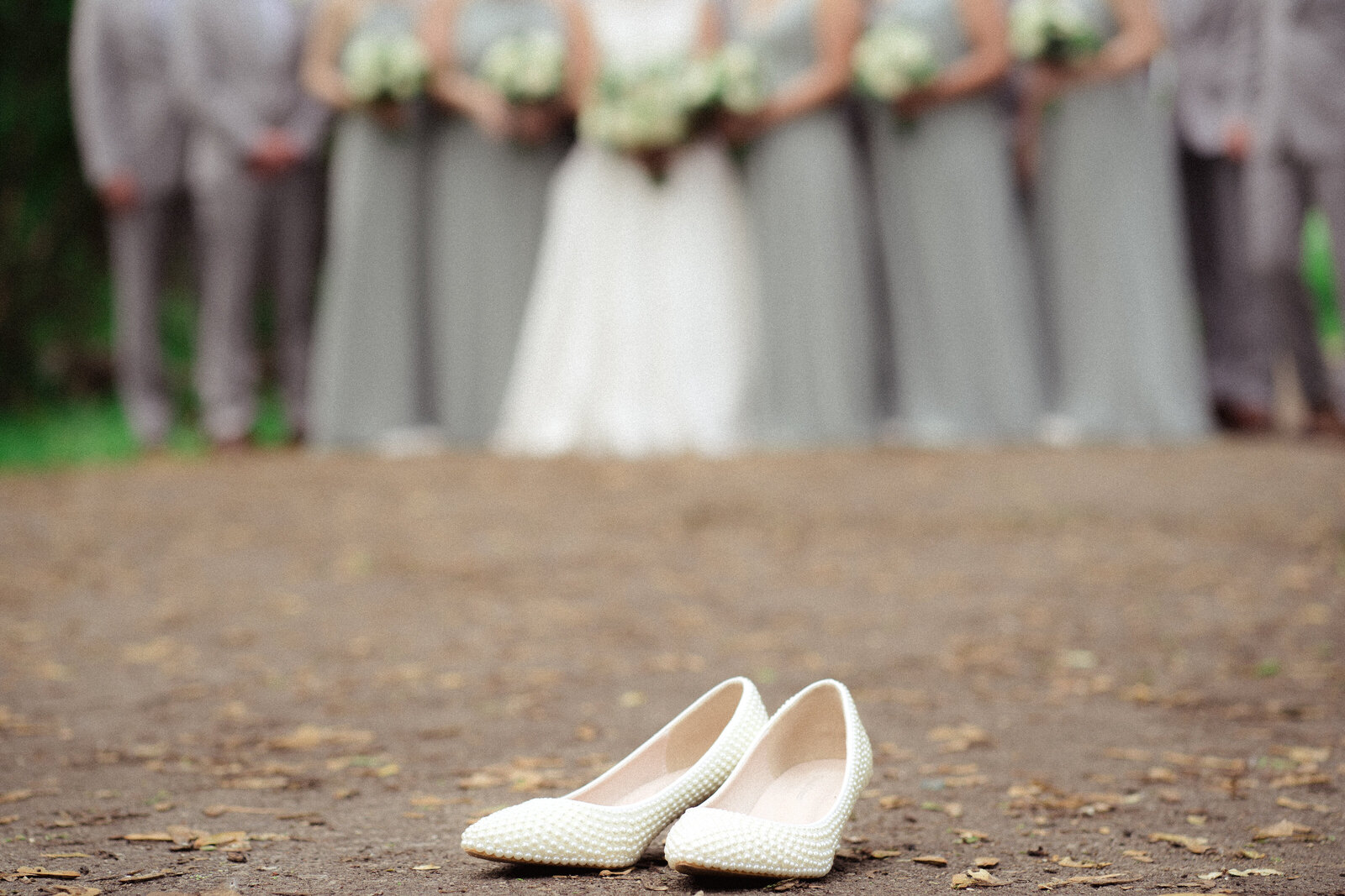 bride left pearl covered shoes on side during portraits