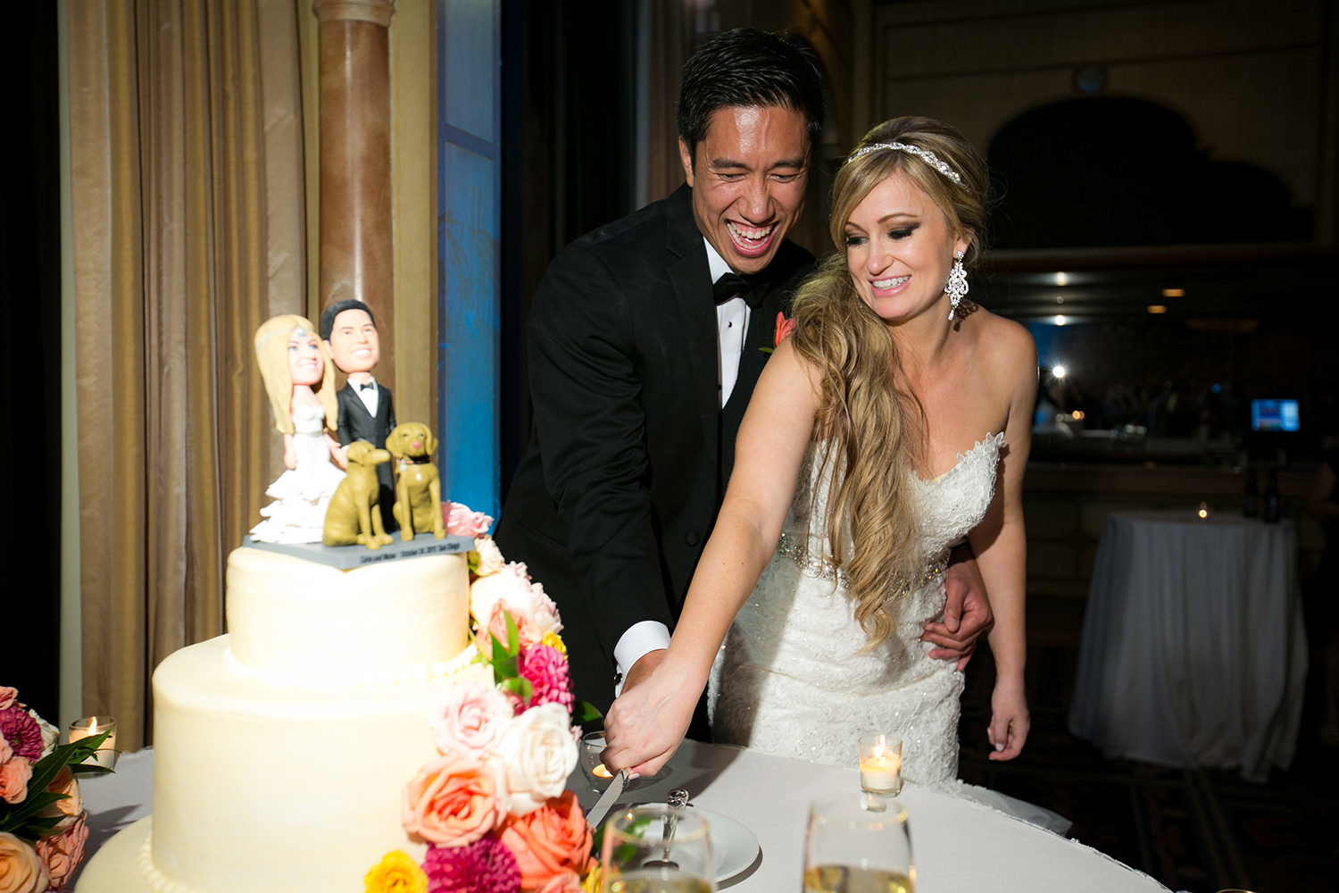 bride and groom cake cutting laughing