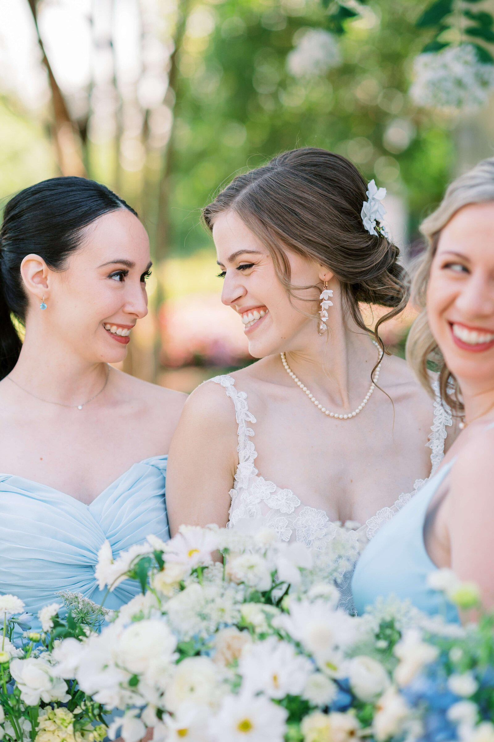 Bride laughs with her bridesmaids at their Virginia wedding