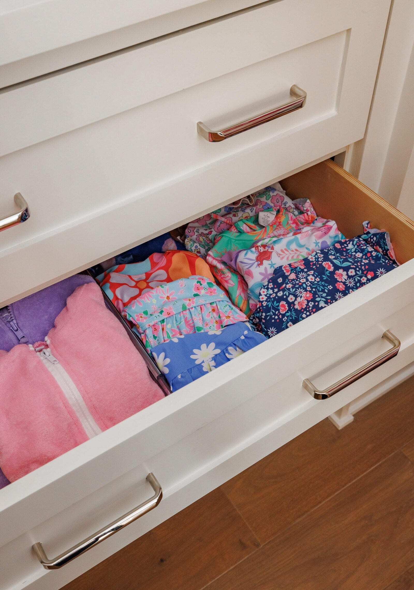 vision and hammer organizing girls drawer with folded clothes