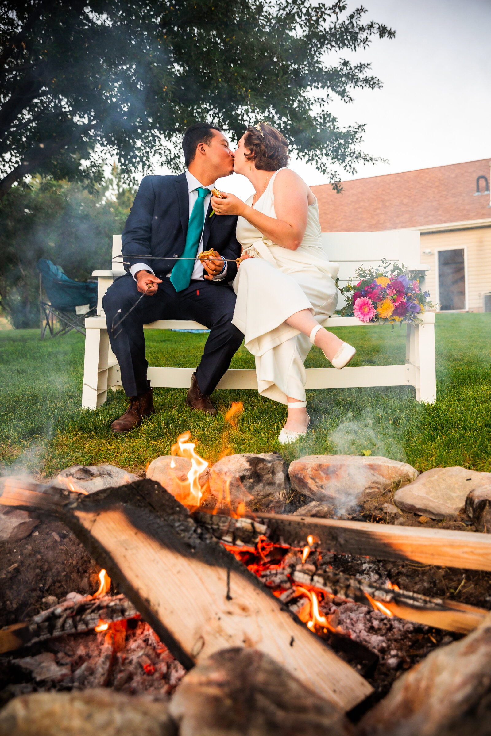 Jackson Hole photographers capture couple roasting marshmallows after Grand Teton wedding