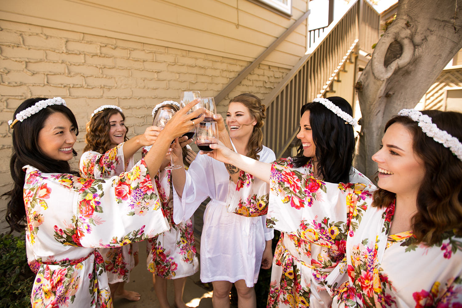 bride laughing with bride maids getting ready