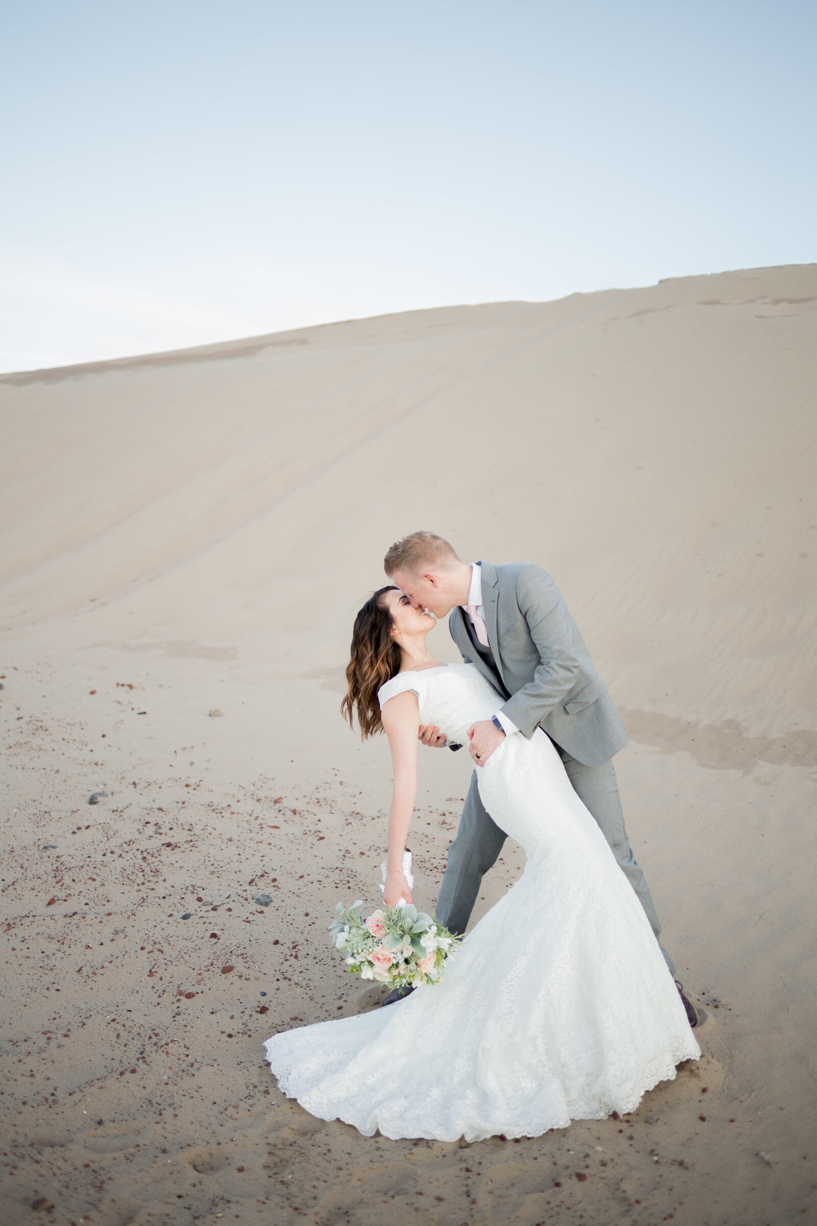 Washington Elopement Photographer captures bride and groom kissing during sand dune portraits