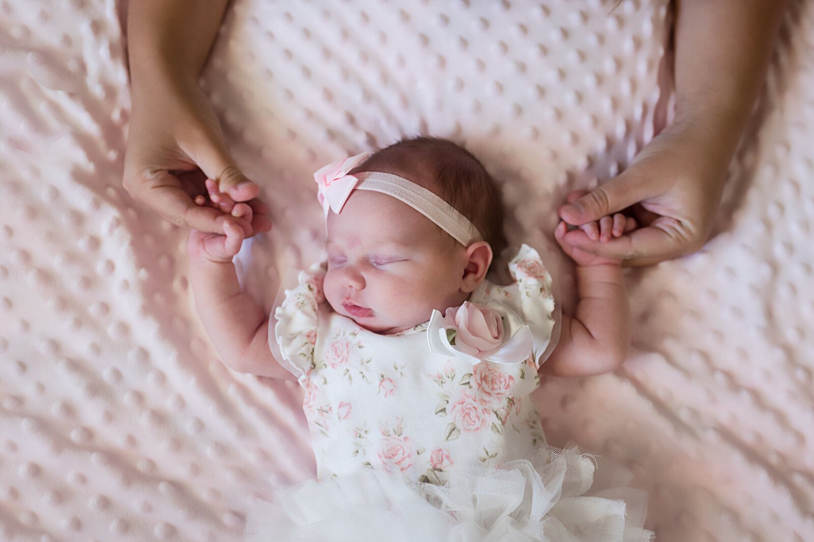 Newborn girl in home photos with moms hands