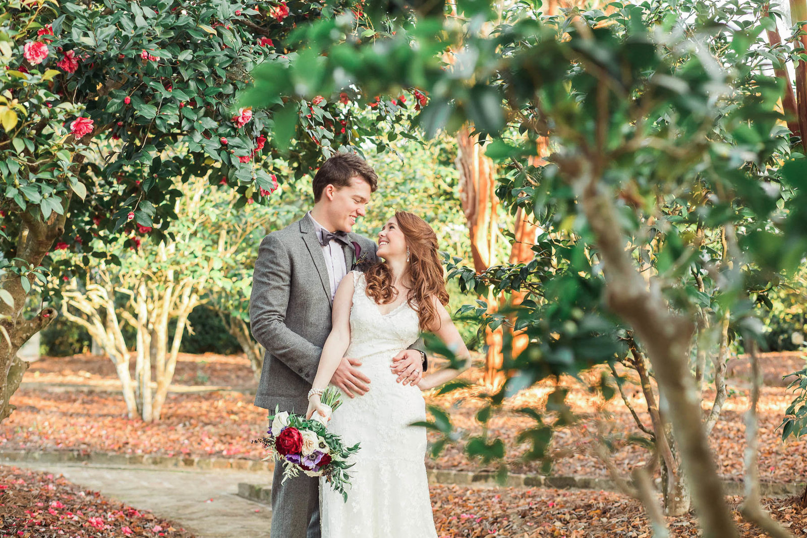 Bride and groom stand in garden at sunset, Boone Hall Plantation, Charleston, South Carolina