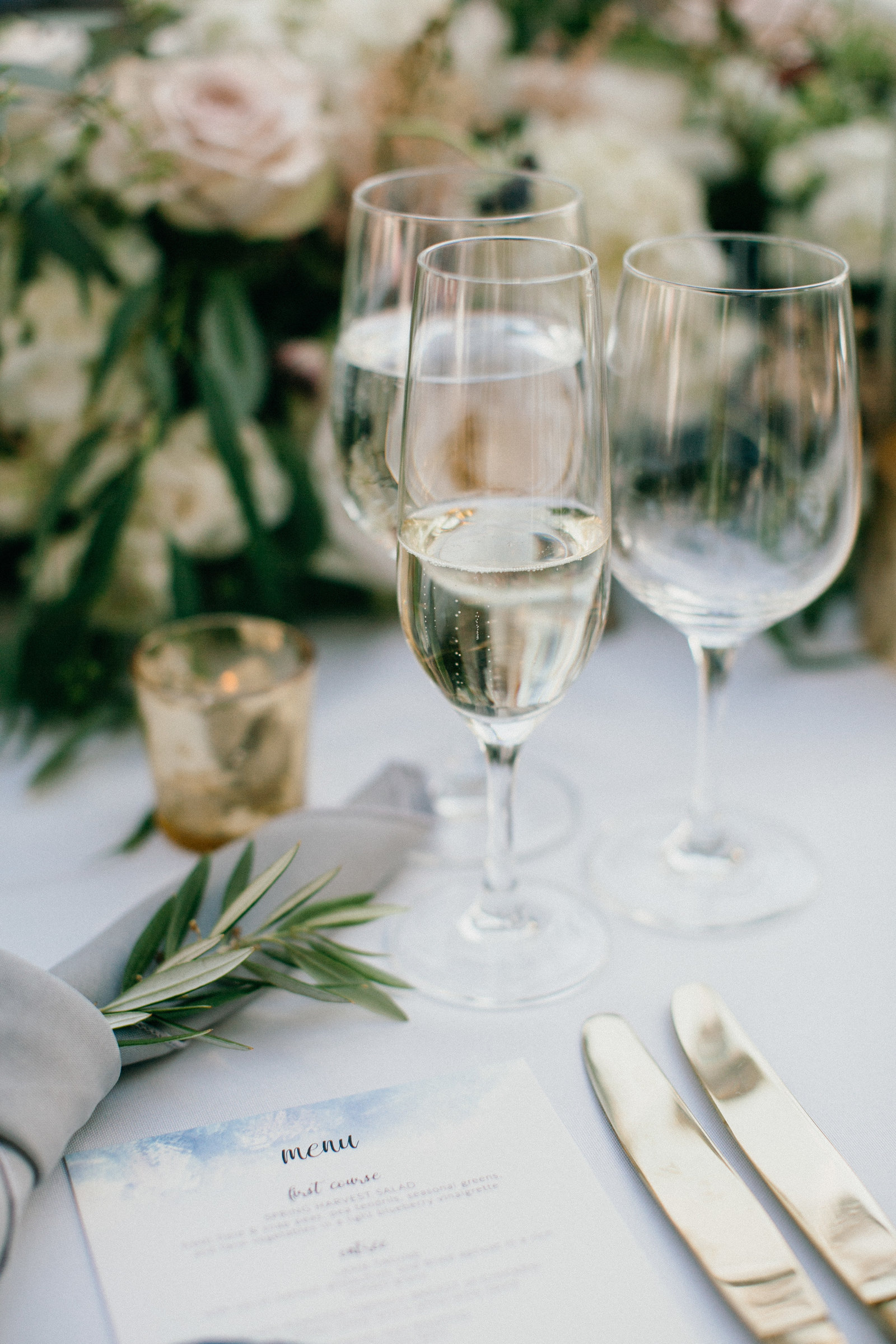 Elegant wedding details displayed on reception tables .