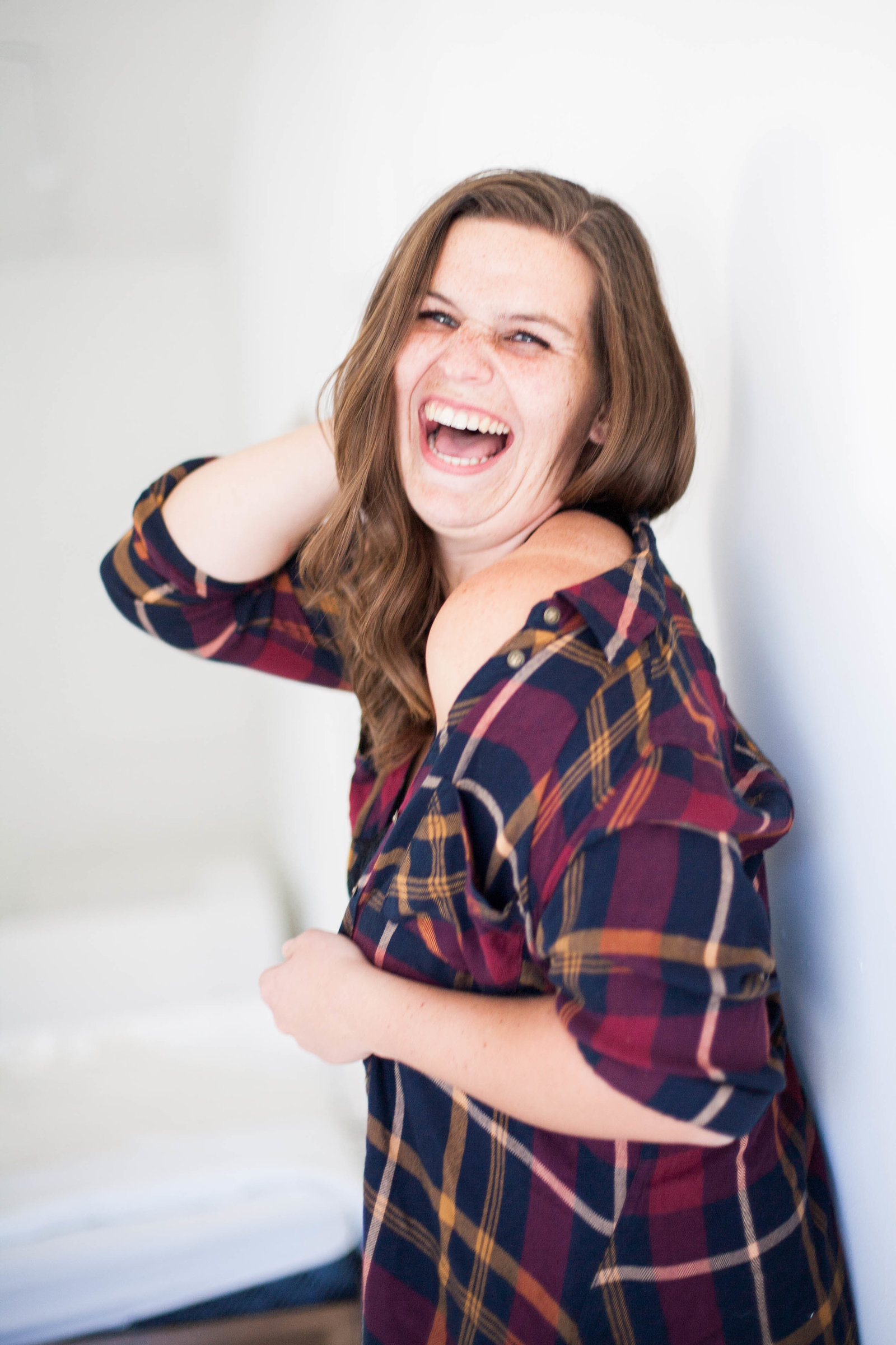 A woman with brown hair laughing.