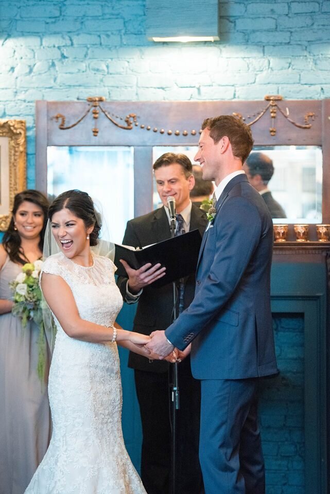 Bride smiles out at her guests during wedding ceremony
