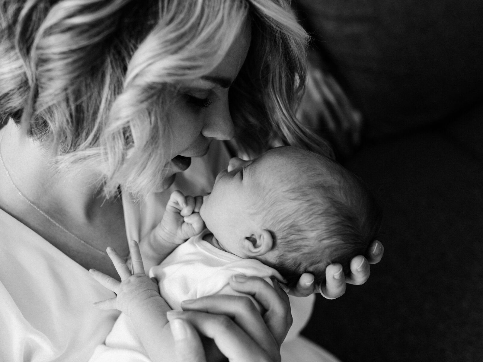 mom holding newborn baby girl for in home photoshoot
