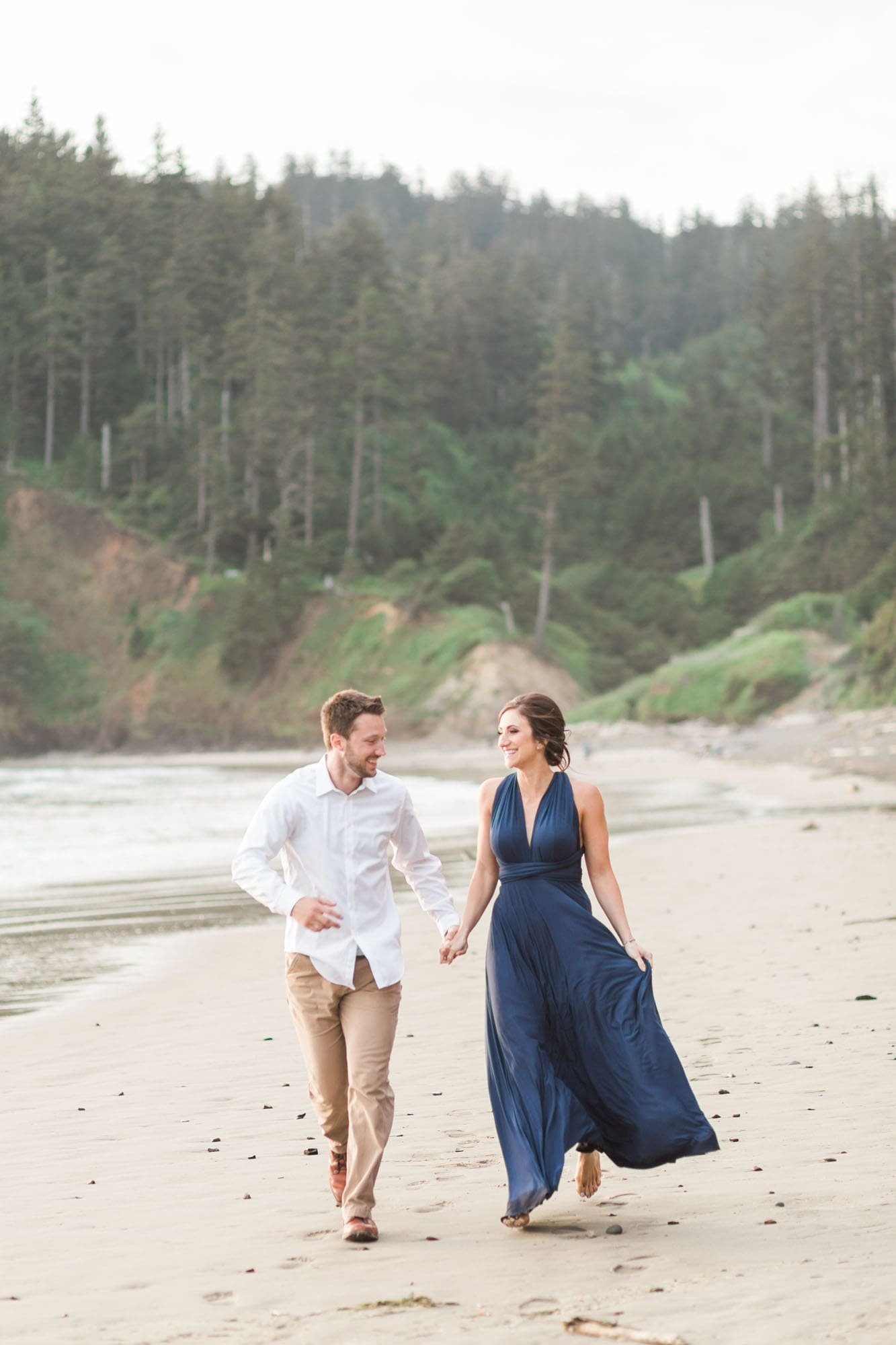 Couple holds hand during Cannon Beach engagement photos
