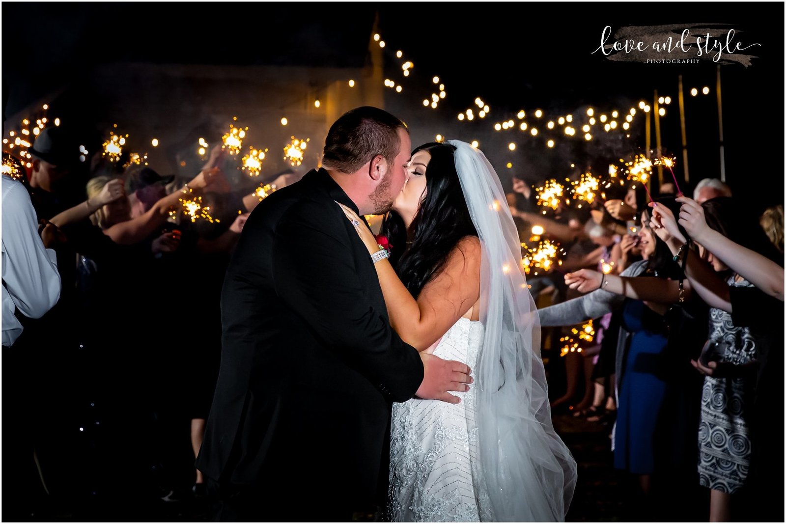 Bride and Groom kissing with sparklers The Barn at Chapel Creek, Sarasota Florida