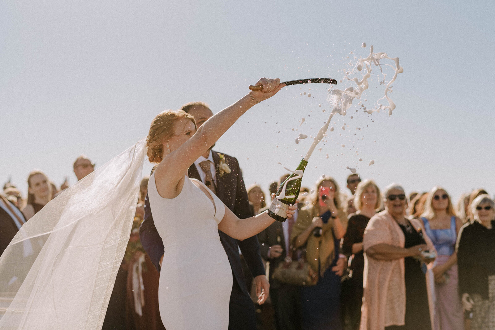 Bride sabers champagne at Albatross Ridge