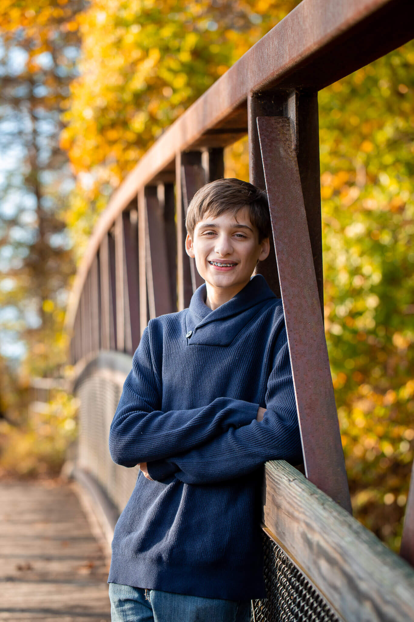 A boy leaning up against a bridge for Springfield family photographer, Melissa Driggers.