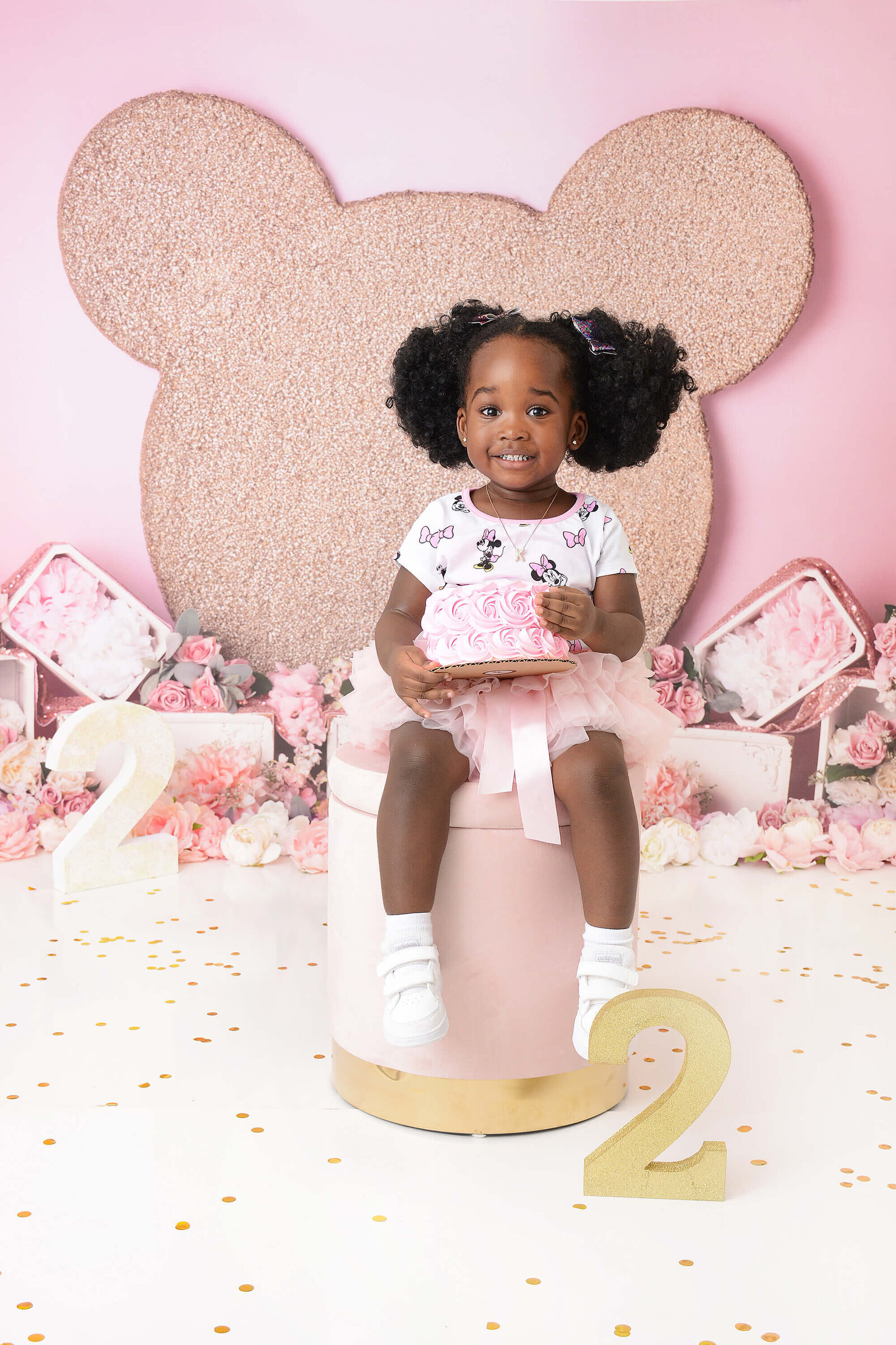 girl smiles at her minnie mouse themed second birthday session