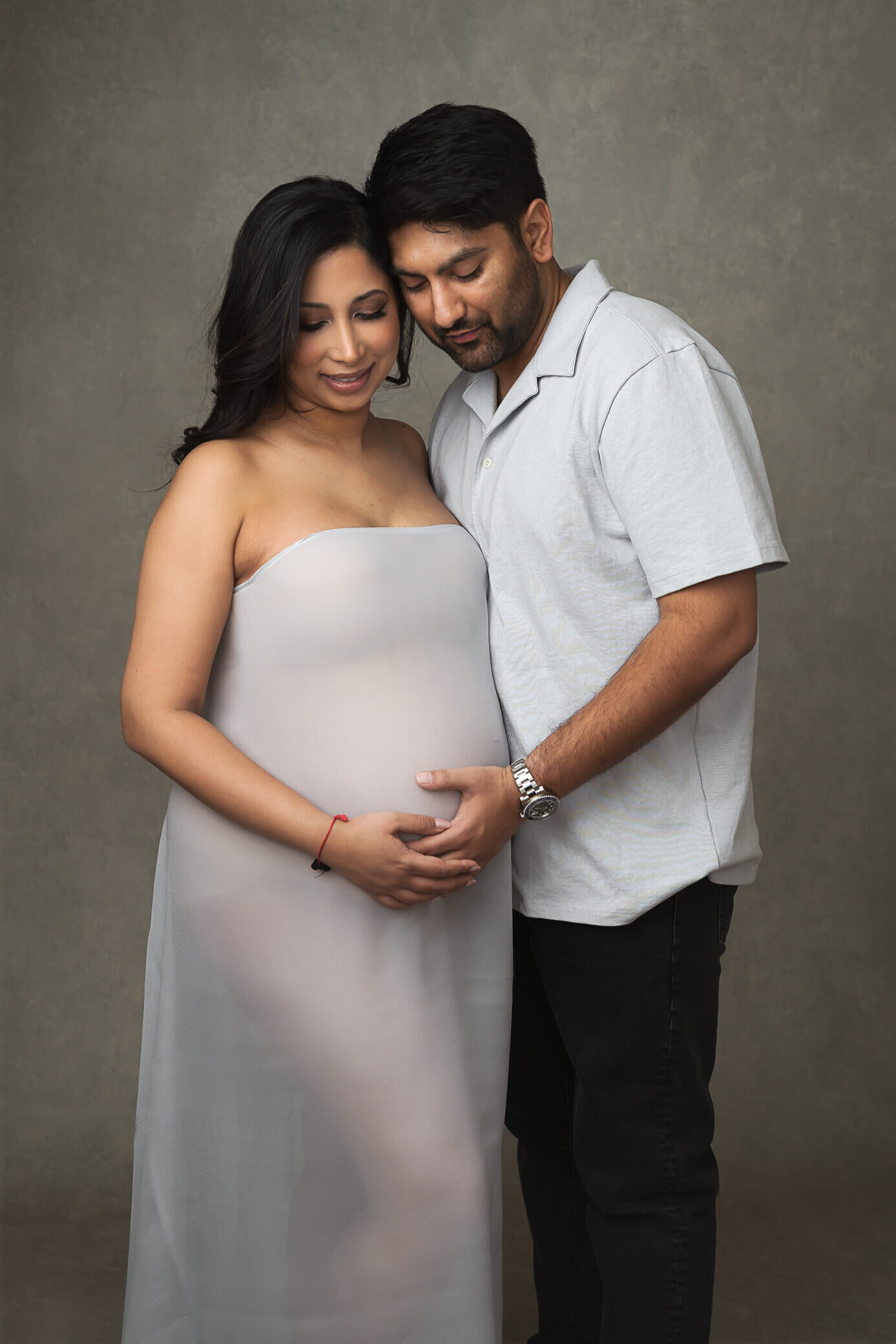 couple maternity photo in studio using fabric