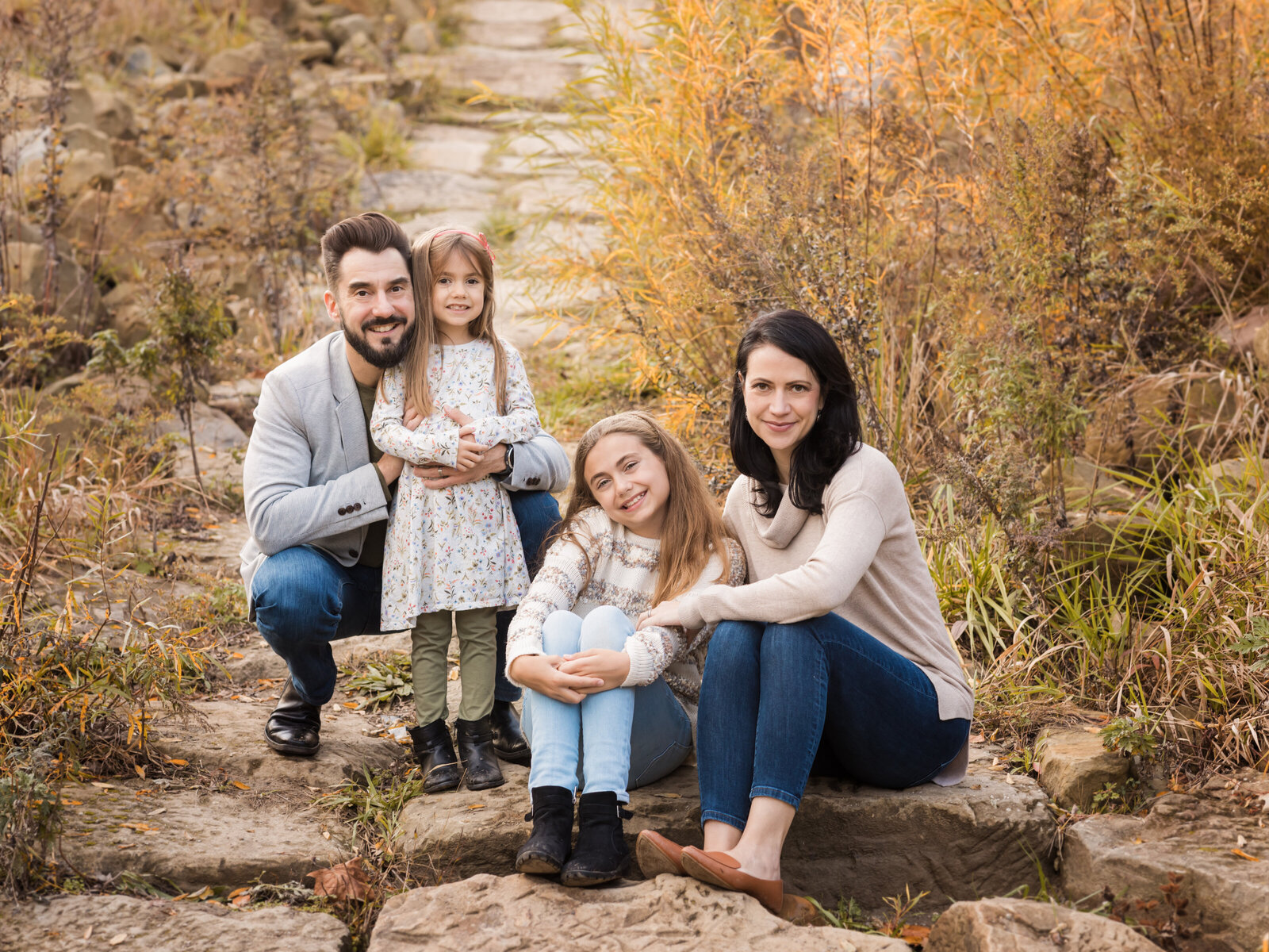 family sitting on steps at cuyahoga valley park for family photos