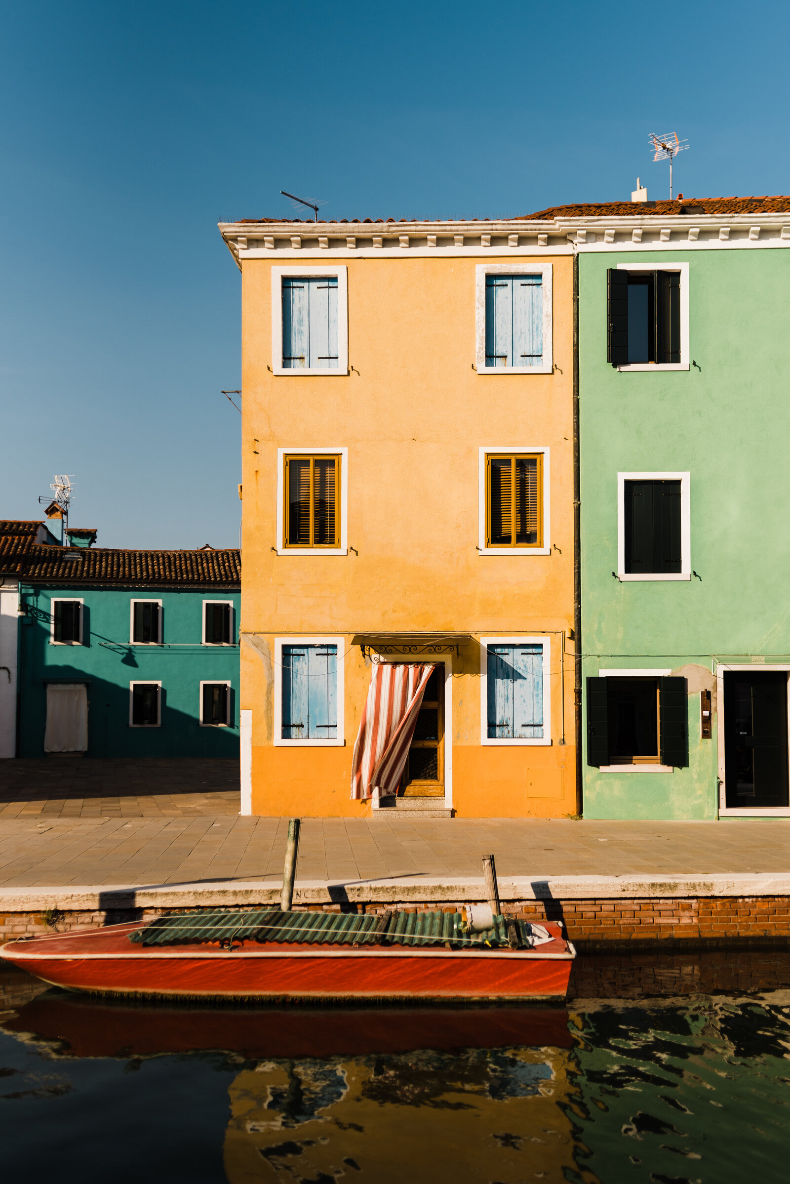 Yellow and green houses in Burano, Italy