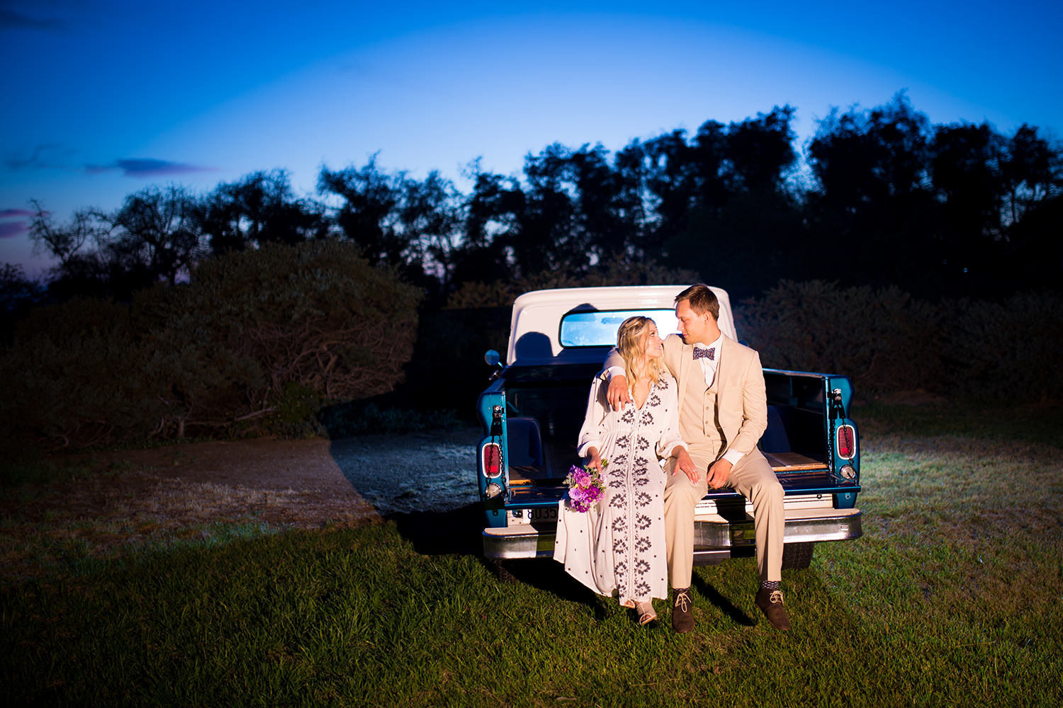 rustic blue truck with bride and groom sitting