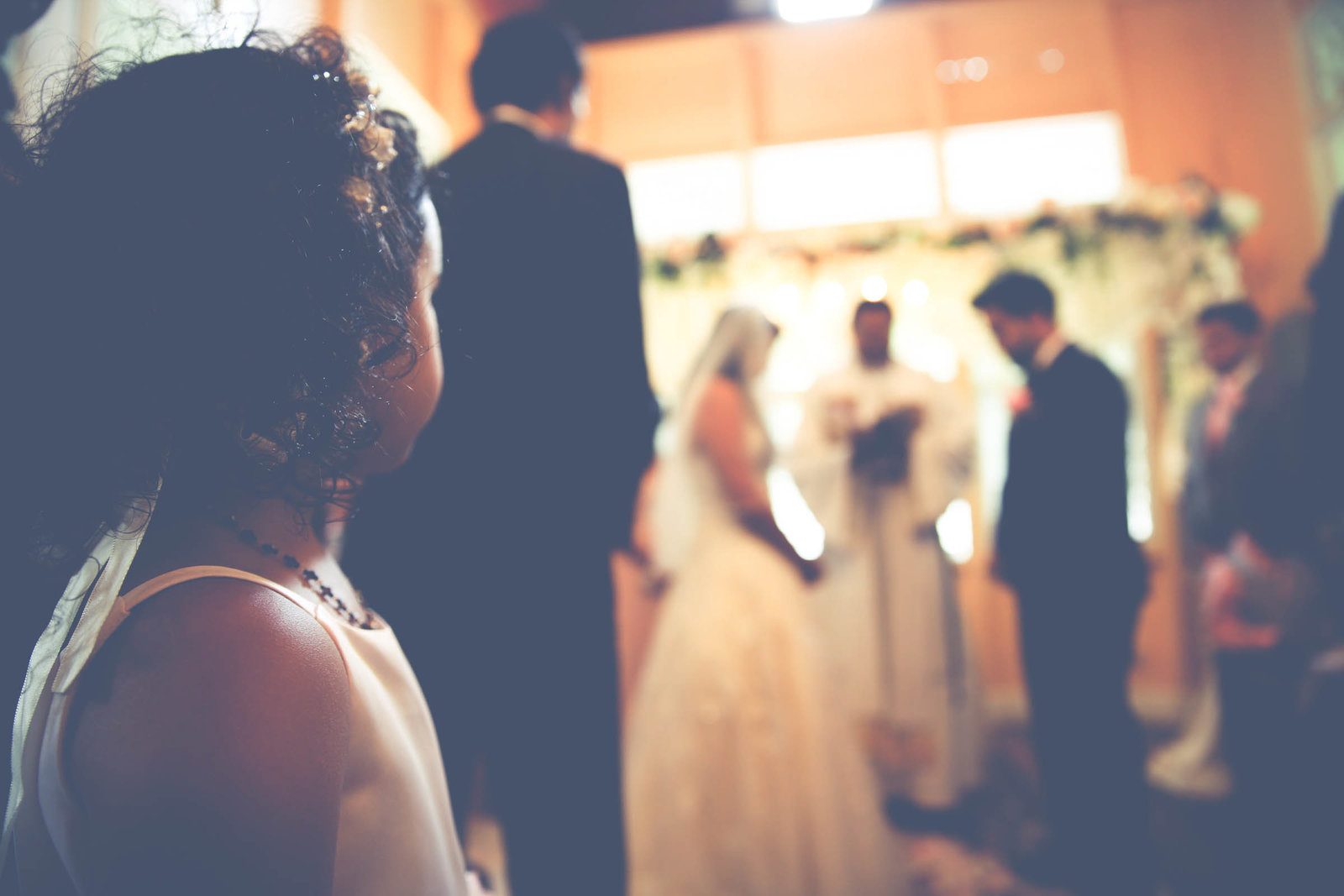 Little girl looks on as bride and groom get married. Photo by Ross Photography, Trinidad, W.I..