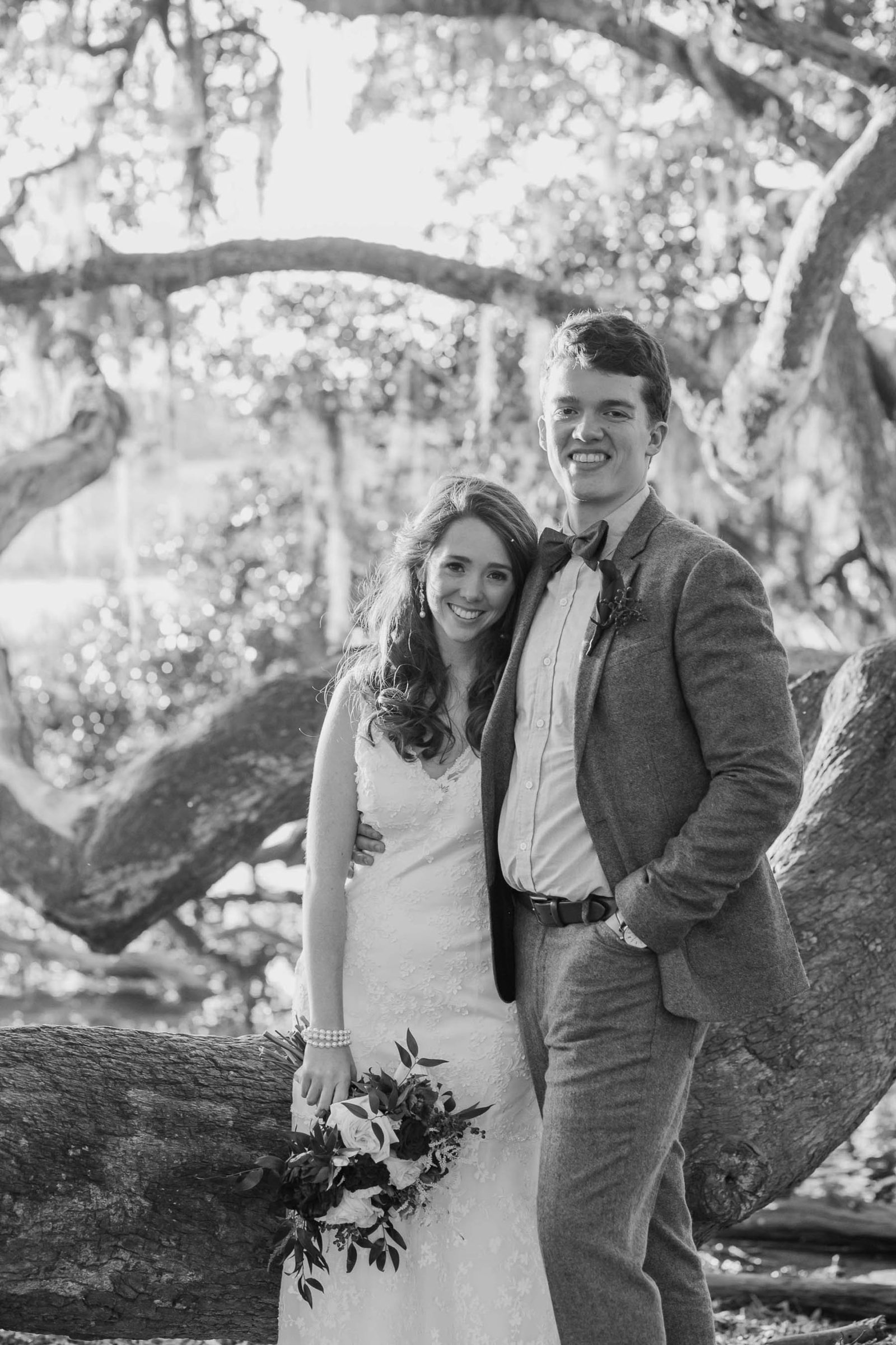 Bride and groom stand in oak tree with spanish moss, Boone Hall Plantation, Charleston, South Carolina