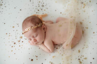Best Baby Photographer in Charleston, SC poses Infant for Newborn Photoshoot.