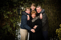 Family of four pose for a photo on a cold winter day