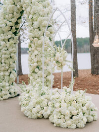 Outdoor church window wedding altar covered in white flowers