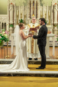Bride and groom portrait during the wedding ceremony in a Los Angeles church with warm light and a documentary feel.