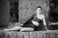 Boudoir experience outside model seated sideways sunset at time and space
