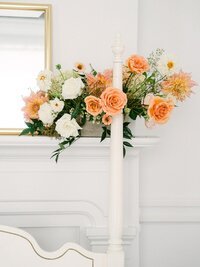 Peach and white floral mantel arrangement with taper candle by Flowergirl Cville, Charlottesville area florist | Photo by Lyn Waldrop Photography