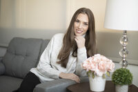 Female entrepreneur relaxing on a couch during a lifestyle headshot photography session in Ventura County.