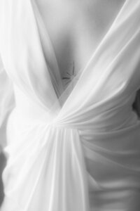 Macro film shot of intricate wedding dress lace and fabric, highlighting luxury bridal fashion and craftsmanship.