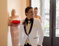 Venice Beach Los Angeles wedding photography of the groom looking back down the aisle to see if the bride is coming, captured in a candid documentary moment with true to life color and emotional