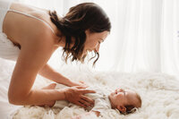 Charleston Mini Sessions - Mother embraces her baby during Mother's Day Mini Session at Holy City Babies in Charleston, SC.