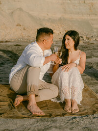 A serene engagement moment at The Lodge at Torrey Pines captured by Michael Asmussen Photography. Amid whispering pines and timeless California architecture, the couple celebrates with rosé and effortless laughter—an image of warmth, elegance, and genuine connection.