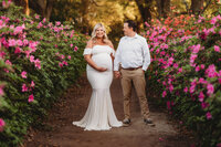 Expectant parents pose for Spring Maternity Portraits in Hampton Park in Charleston, SC.