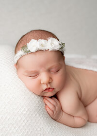 baby girl with white flower bow
