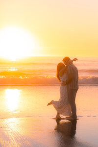 sunset beach couple dancing on sand barefoot in santa cruz.