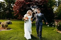 Bride and groom walking on Duncan Memorial Chapel grounds